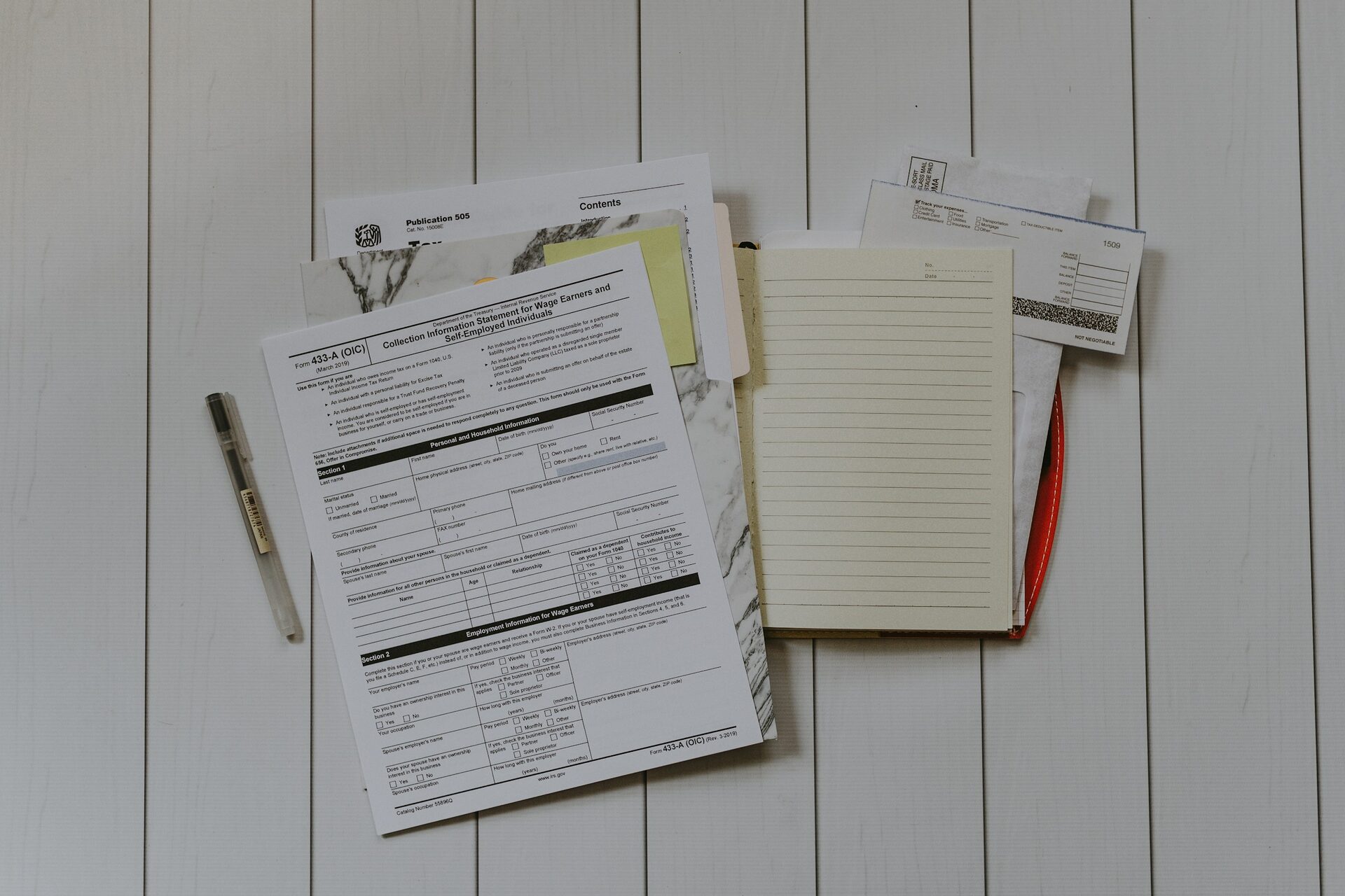 stack of papers flat lay on a desk